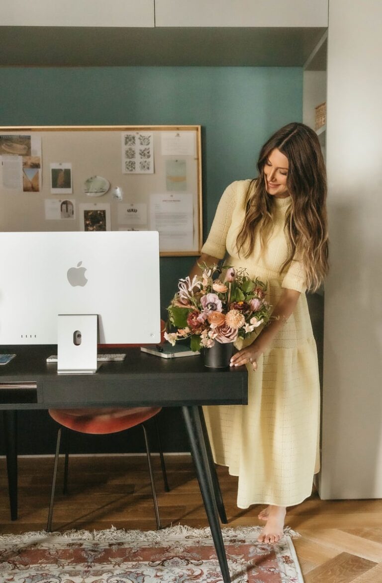 Roxana Saidi adorning her home office desk with plant